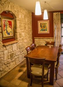 a dining room with a wooden table and chairs at El Soportal de Uceda in Uceda