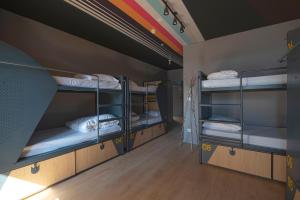 a room with three bunk beds in a room at CATS Porto Hostel in Porto