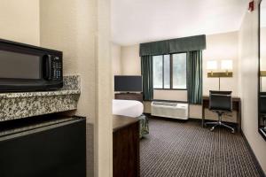 a hotel room with a bed and a television at Travelodge by Wyndham Yuma in Yuma