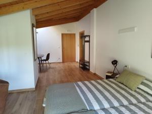 a bedroom with a bed and a table in a room at Balcón del Aitzgorri in Mutiloa