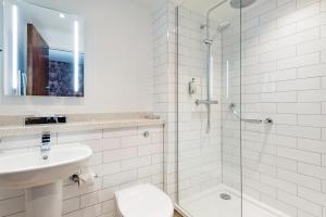 a bathroom with a shower and a toilet and a sink at The Hand & Sceptre by Innkeeper's Collection in Southborough