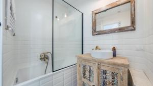 a bathroom with a sink and a mirror at Apartamenty Sun & Snow Parkowa in Sopot