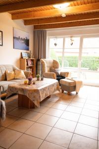 a living room with a couch and a table at Tillmann II in Hooksiel mit Hund in Wangerland