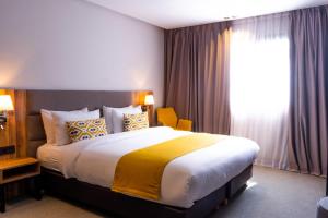 Postel nebo postele na pokoji v ubytování Urban Hotel & Spa