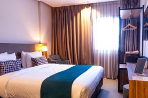 Postel nebo postele na pokoji v ubytování Urban Hotel & Spa