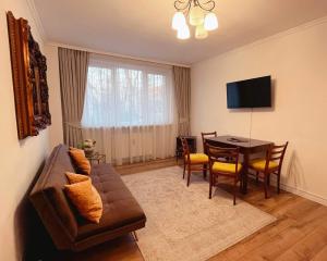 a living room with a couch and a table at Niran Apartament in Oradea