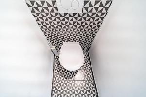 a white toilet in a bathroom with black and white tiles at Superb 1 bedroom apartment - Croix Rousse district in Lyon
