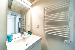 a white bathroom with a sink and a mirror at Superb 1 bedroom apartment - Croix Rousse district in Lyon