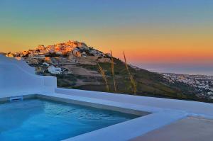 a villa with a swimming pool with a mountain at Martynou View in Pirgos