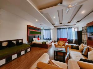 a large living room with a bed and a couch at Hotel Bliss in Kasauli