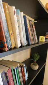 a row of books on a shelf with a potted plant at Trippers hostel in Darjeeling