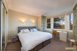 a bedroom with a bed and a desk and a window at Seascape in North Berwick