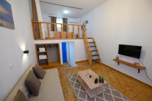 a living room with a couch and a loft at Verano Apartments in Kalymnos