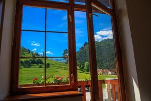 a window with a view of a green mountain at Hotel Gold in Terchová