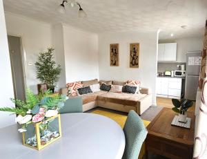 sala de estar con mesa y sofá en 2 bed apt w/ private parking close to town centre, en Huntingdon
