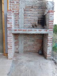 a brick fireplace in the side of a building at Departamento El Renuevo in Vista Flores