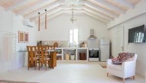 a kitchen and living room with a table and chairs at Penelope - Sea View House in Evretí