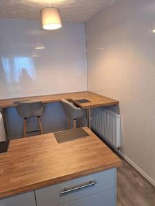 an empty office with two desks and two chairs at 1 Bed Apart in Dowlais