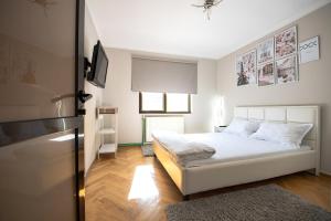um quarto com uma cama e uma televisão em Apartament S46 em Roman