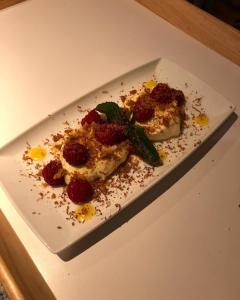 a white plate with a dessert on a table at Down The Garden Path Vintage Caravan B&B , Dartmoor in Newton Abbot +43 photos