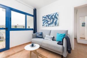 a living room with a couch and a table at Home2Book Aloha Palm in Costa Calma