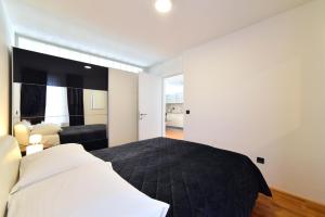 a bedroom with a bed and a living room at Lavir Apartment with parking in Zagreb
