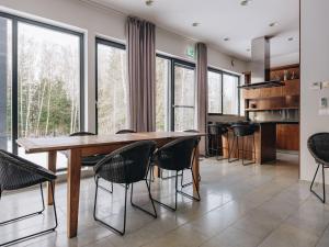 a dining room with a wooden table and chairs at Villa Saskia in Otepää