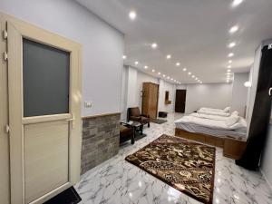 a room with two beds and a large sliding door at Life Pyramids Inn in Cairo