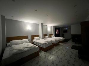 a group of three beds in a room at Life Pyramids Inn in Cairo