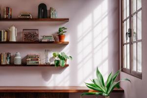 a room with bookshelves and a potted plant at Good Hotel Antigua in Antigua Guatemala