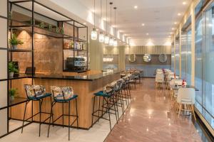 a restaurant with a bar with stools at Hotel Elche Centro , affiliated by Melia in Elche