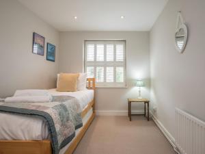 a bedroom with two beds and a window at Pass the Keys Cosy 6 Sleeper House Central Windsor in Windsor