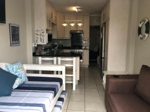 a living room with a couch and a kitchen at 8 Ocean Drive Self Catering Unit in Ballito +4 photos