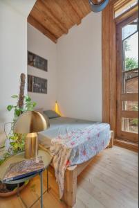 a bedroom with a bed and a table with a lamp at Luxury House in Tbilisi City