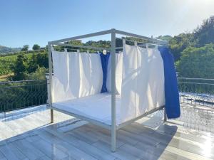 a canopy bed on top of a deck at Serra Marina Rooms and Apartments in Santa Maria di Castellabate