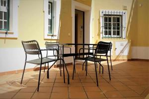 a black table and chairs sitting on a patio at AlgarveSand Porches in Porches