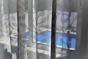 a view of a bed through a window at AlgarveSand Carvoeiro in Carvoeiro