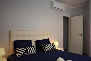 a bedroom with a blue bed with two pillows at AlgarveSand Carvoeiro in Carvoeiro +38 photos