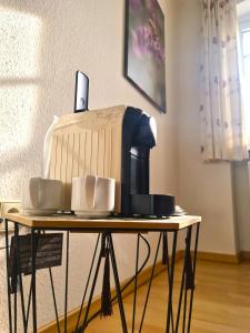 a coffee maker sitting on top of a table at Gästehaus Zum Weinbauer in Rhodt unter Rietburg