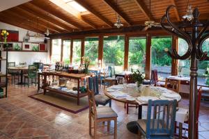 a dining room with tables and chairs and windows at Hotel Restaurante Cabo Vidío in Oviñana