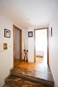 a living room with a staircase leading to a bedroom at Apartamentos Caleiro 4P - Vilanova de Arousa in Villanueva de Arosa