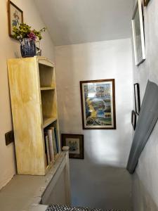 a staircase with a book shelf with books on it at Elm Cottage in Northallerton