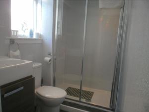 a bathroom with a shower with a toilet and a sink at The Withnell Hotel in Blackpool