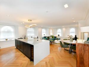 an open kitchen and living room with a table and chairs at Pass the Keys Beautiful 2 Bed Apartment with Parking in the Bay in Cardiff