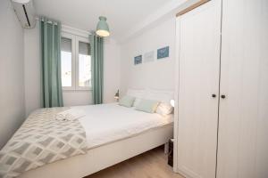 a small bedroom with a bed and a closet at Apartment Sundowner in Zadar