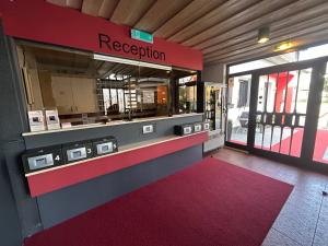 a restaurant entrance with a red and gray counter at Hotel Hasselberg in Kaiserslautern