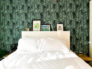 a bedroom with a bed and a green and white wallpaper at Pass the Keys Cosy 2 Bed Apartment with Parking in Cardiff