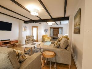 a living room with a couch and a table at The Eller Beck in Skipton