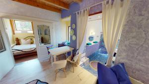 a room with a bedroom and a table and chairs at Boutique Hotel Shambala Zeitlos in Wiedemar