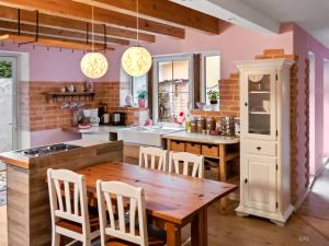 a kitchen with a wooden table and chairs at Boutique Hotel Shambala Zeitlos in Wiedemar
